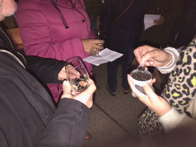 Person using a pen to cross a task off a productivity paper card.